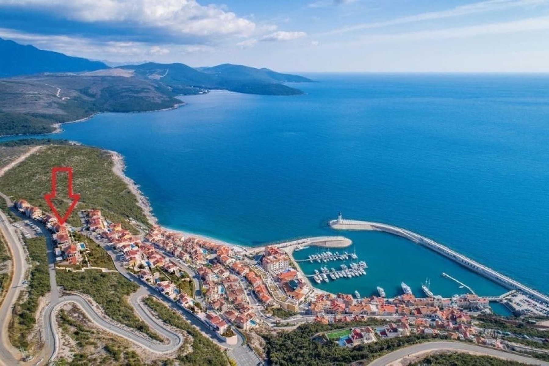 Aerial view of Luštica Bay marina showing the location of the Marina Village apartment