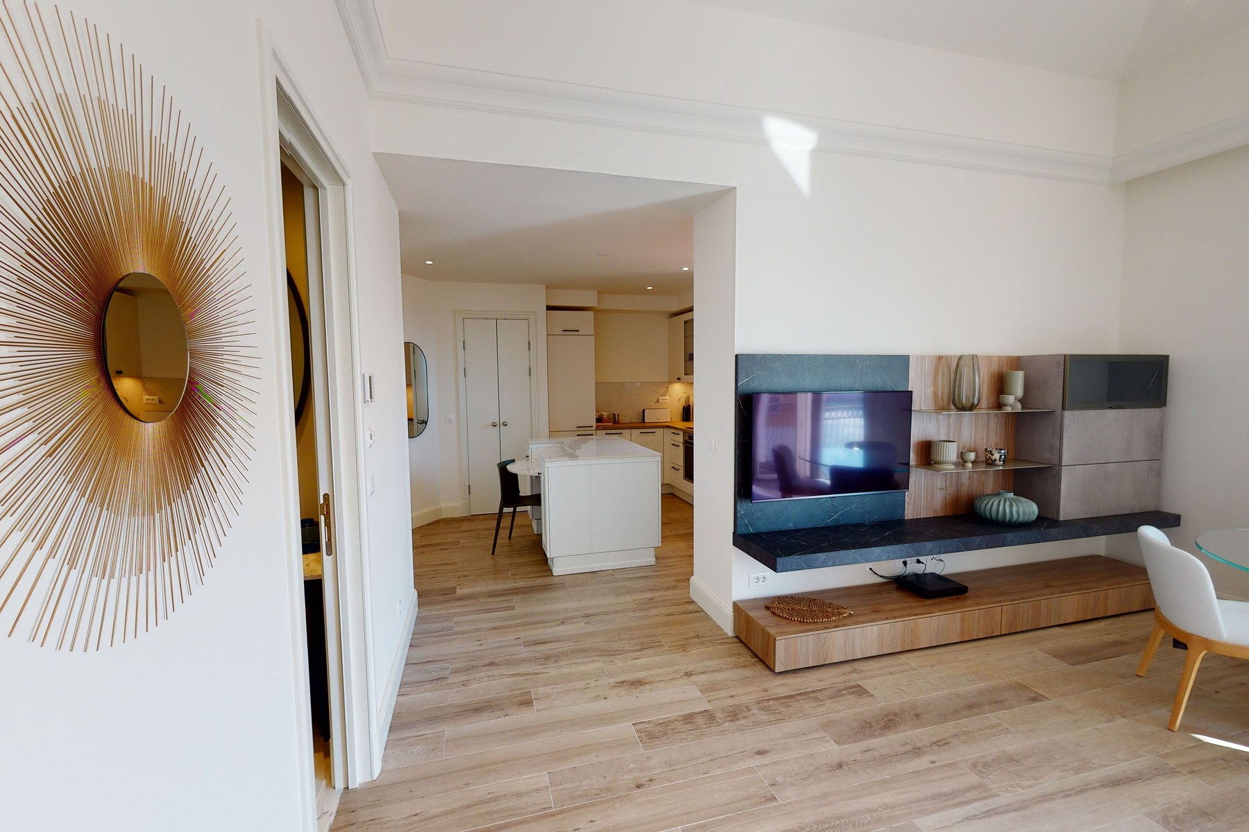 Curated top-floor one-bedroom apartment, hallway with bespoke gold sunburst mirror