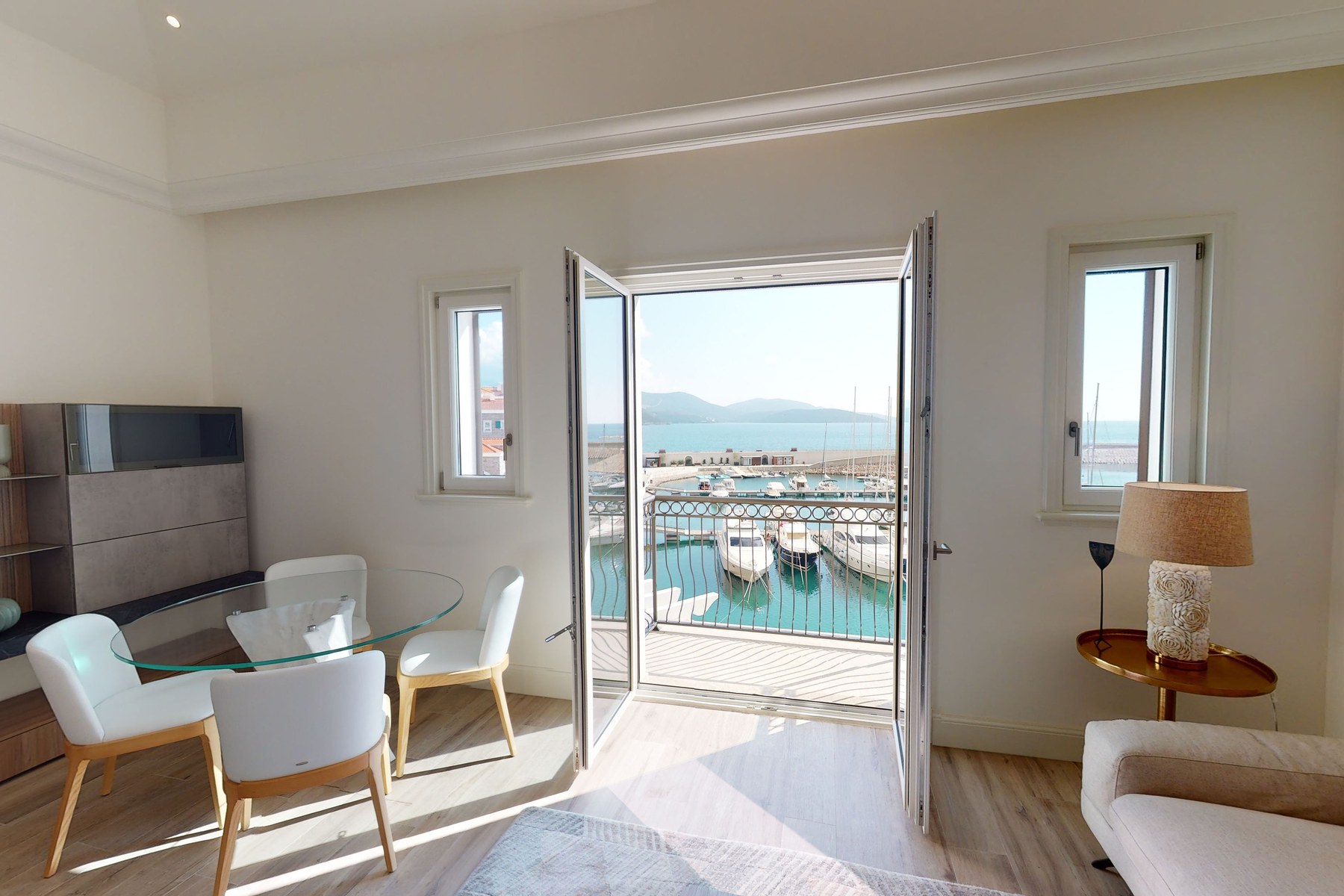 Curated top-floor one-bedroom apartment, living room with doors to the sea-view terrace