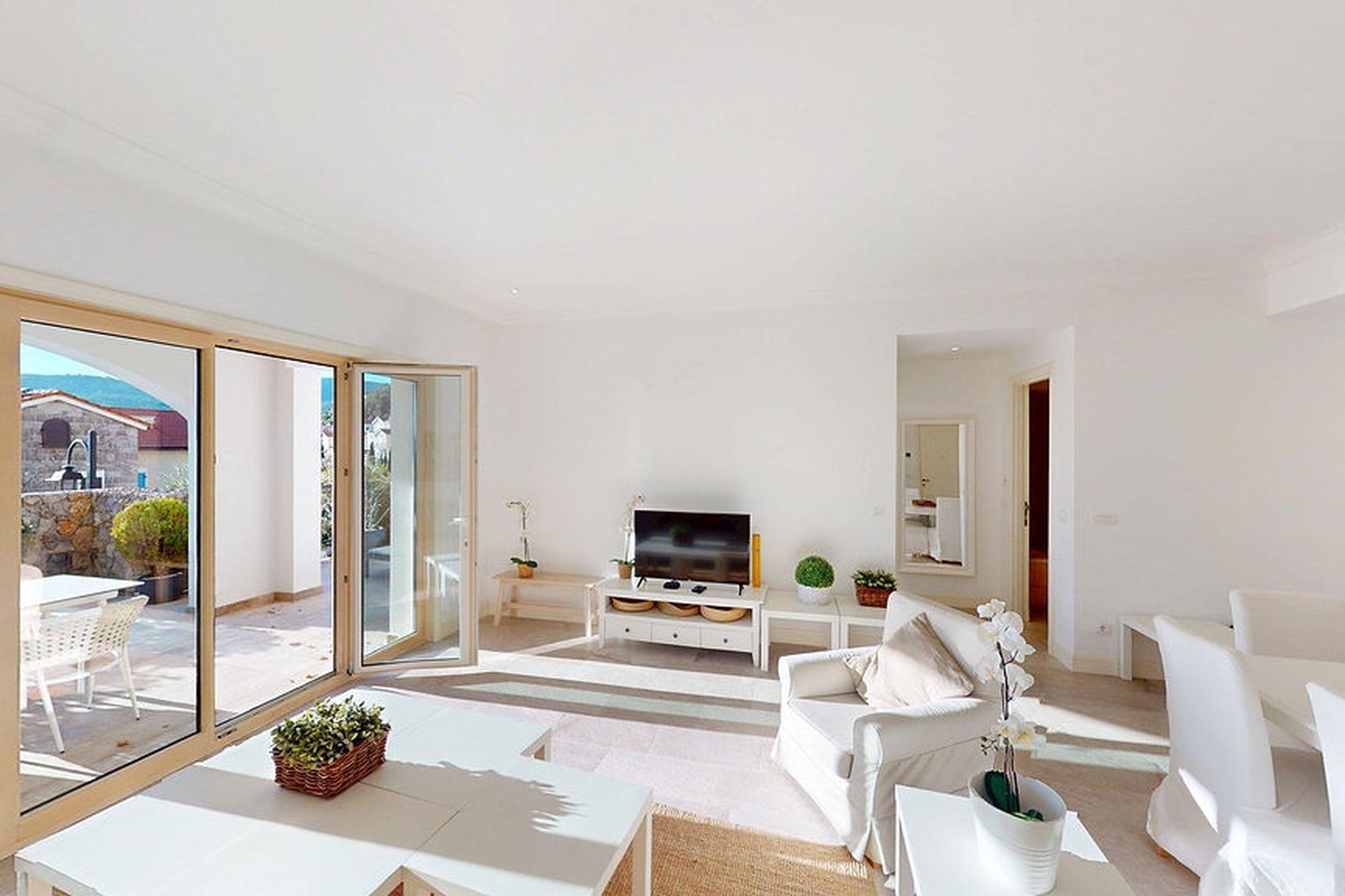 Marina Village garden one-bedroom residence, open living and dining room with sliding doors to the terrace