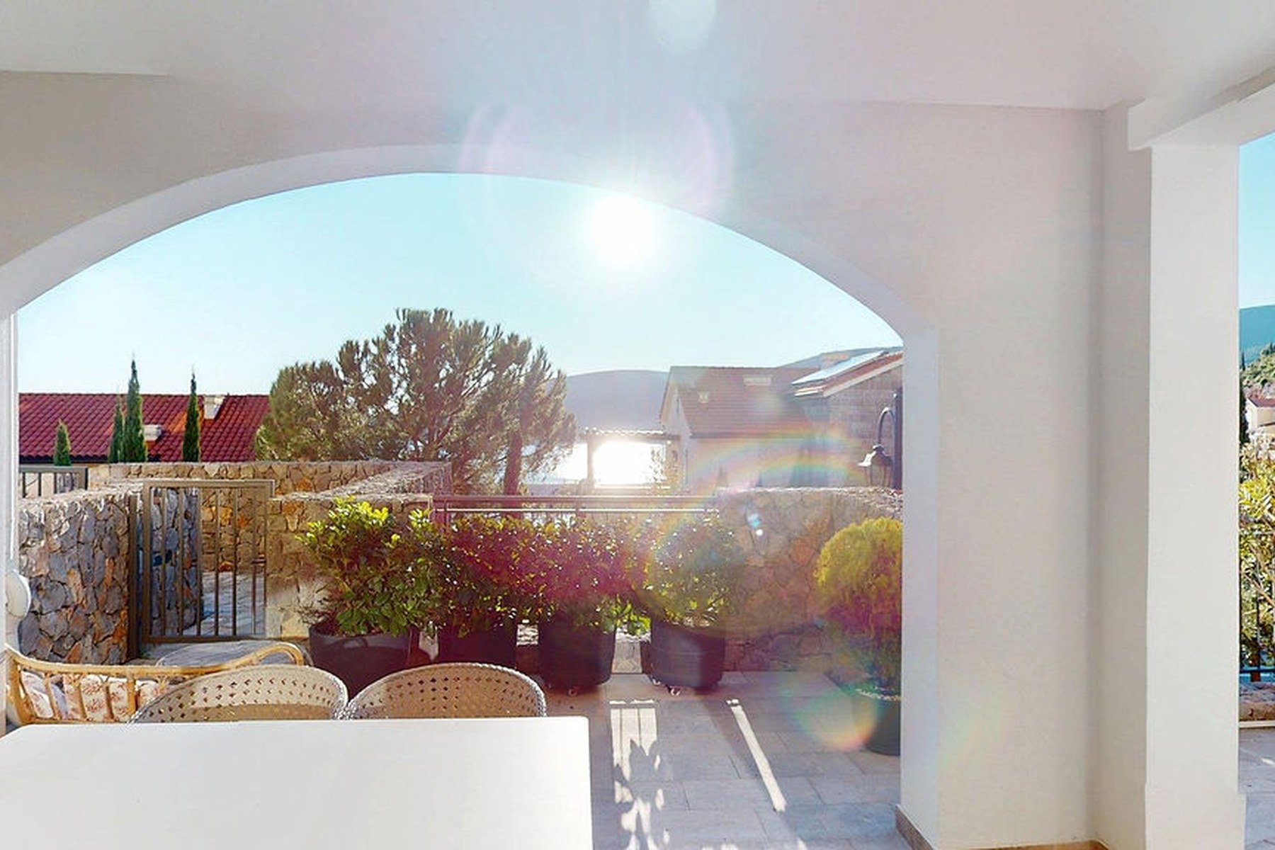 Marina Village garden one-bedroom residence, private terrace with stone walls and Mediterranean planting