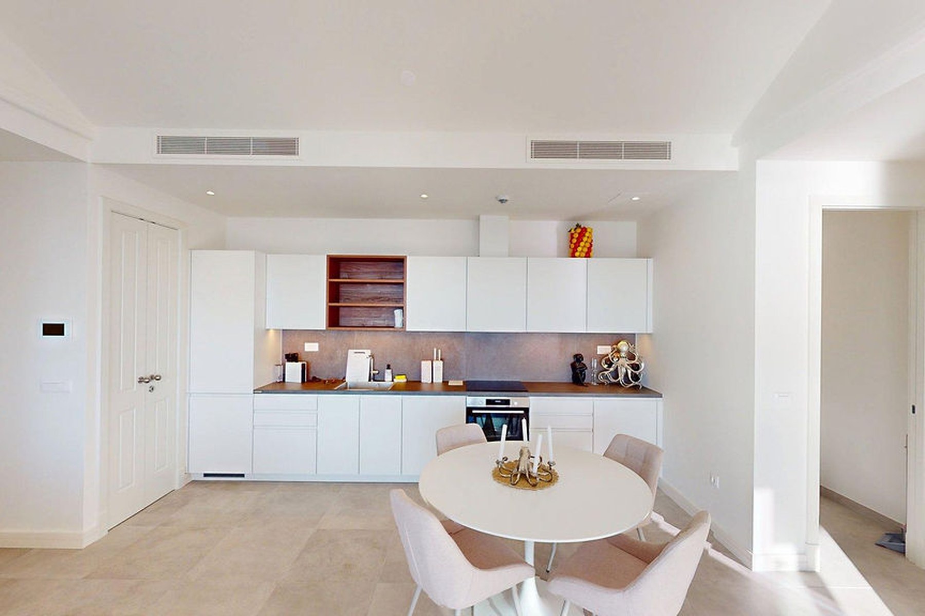 Panoramic top-floor one-bedroom apartment, kitchen and dining under a vaulted ceiling