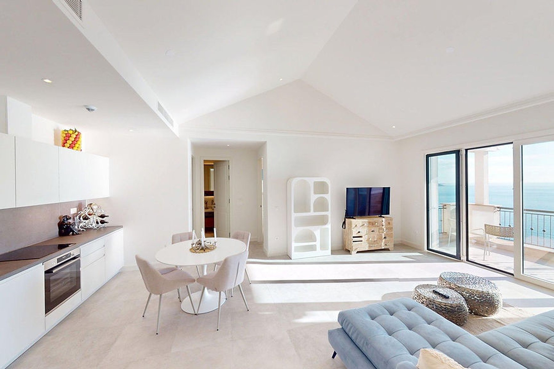 Panoramic top-floor one-bedroom apartment, living room with sea-view sliding doors